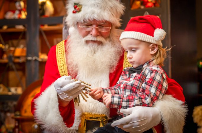 young boy on santa's lap looking at keys