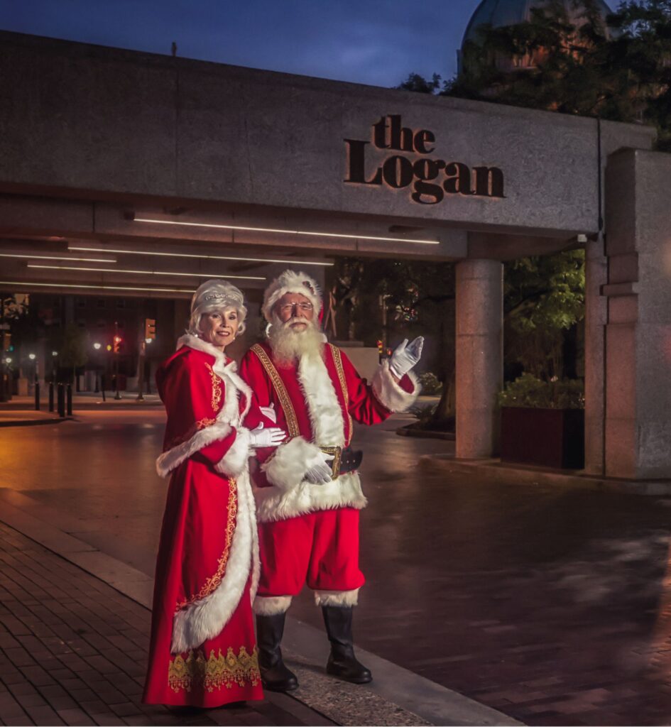 santa and mrs. claus at the logan hotel at dusk