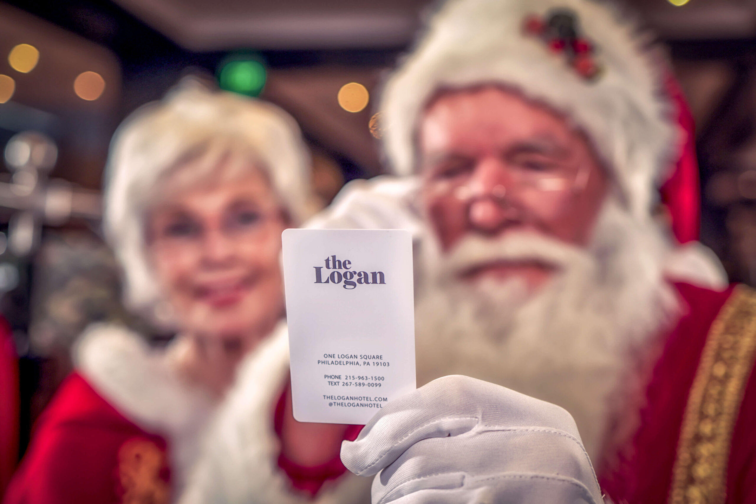 santa and mrs. claus looking at a hotel key card